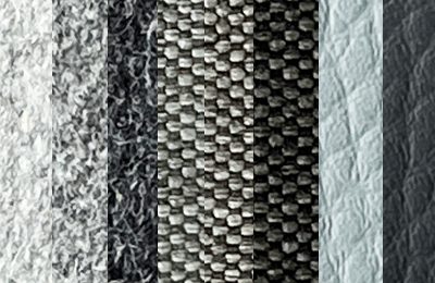 Kunstleder, Webstoff und Wollstoff in verschiedenen Grautönen.